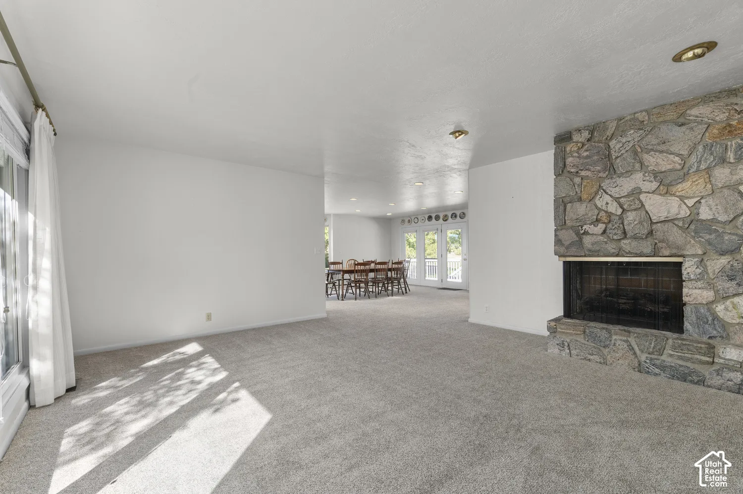 Stone-clad fireplace with a dark metal screen