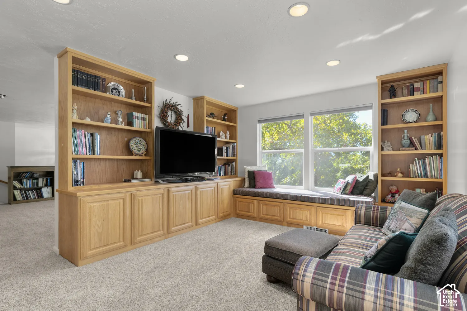 Built-in window seat, recessed lighting, built-in shelving, carpet flooring, multiple windows