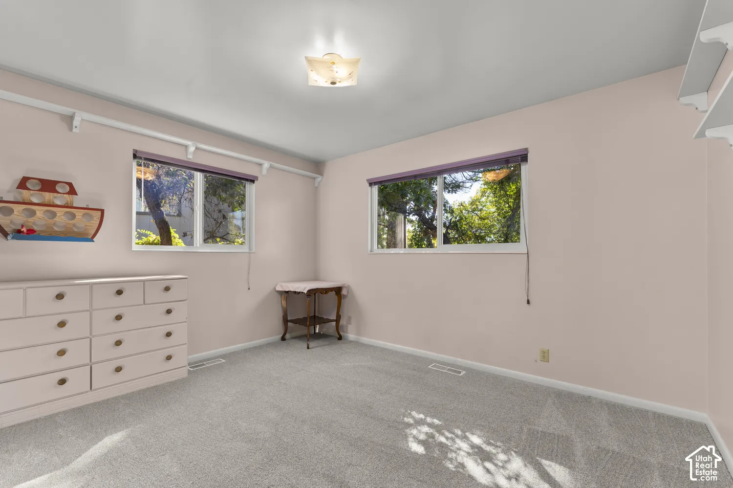 Wall-to-wall carpeting with multiple window openings providing natural illumination
