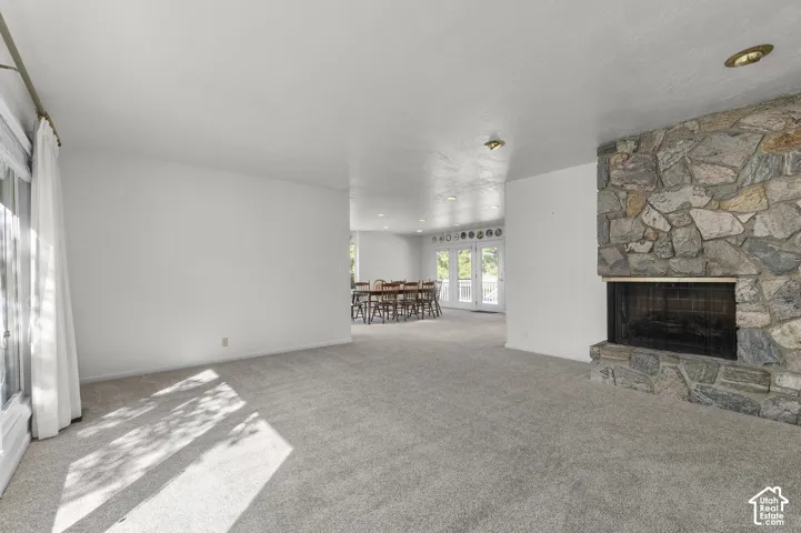 Stone-clad fireplace with a dark metal screen
