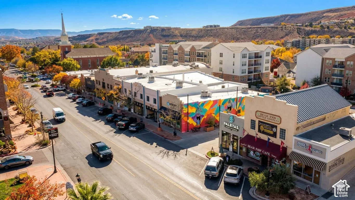 Downtown commercial street with established retail storefronts and upper-level residential units