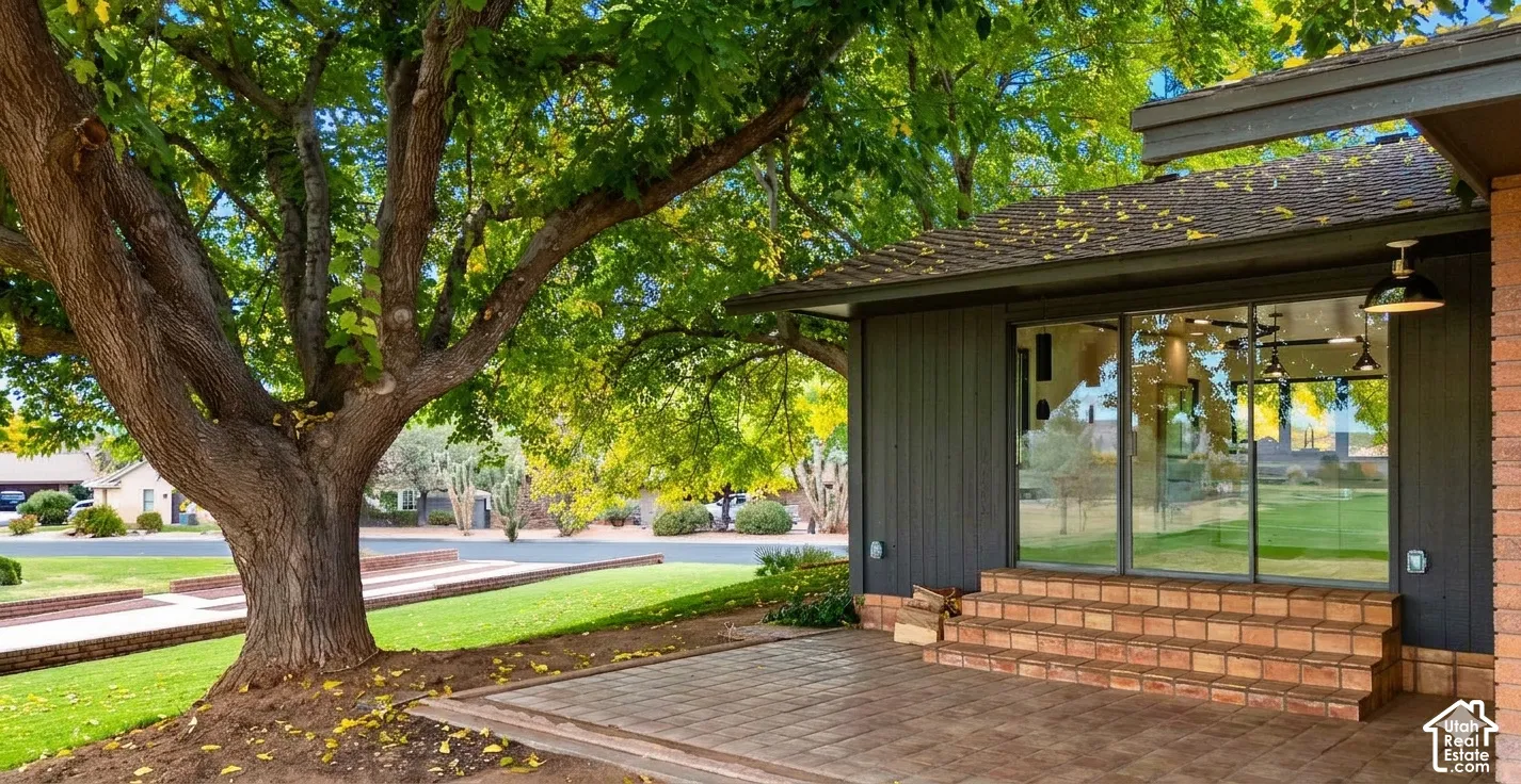 Patio with paver flooring, brick steps, and large glass doors
