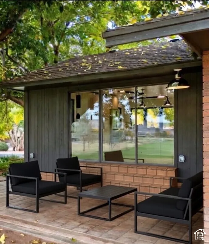Paved patio with brick detailing and full-light windows