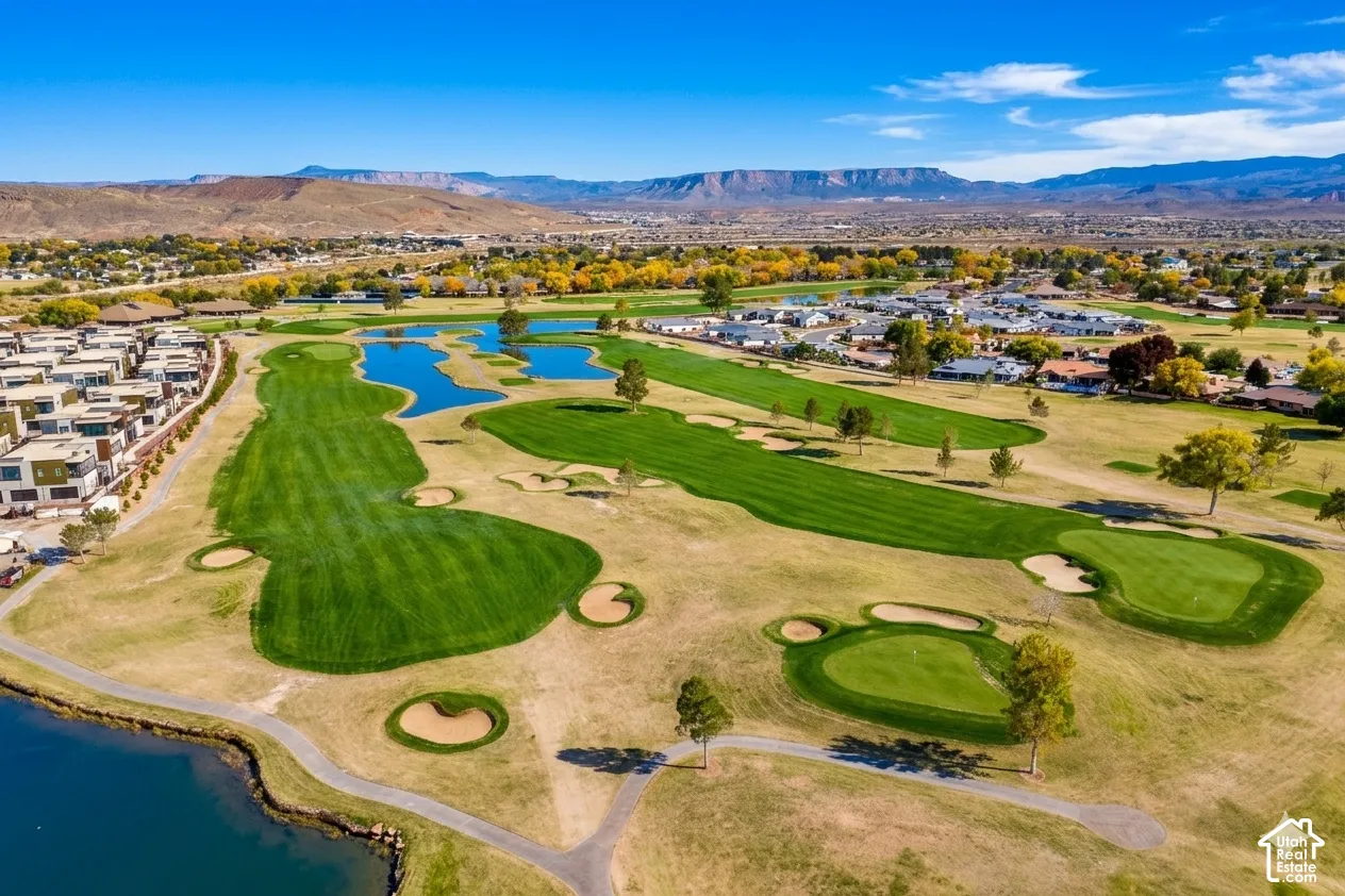 Expansive golf course with multiple greens, sand traps, and water features