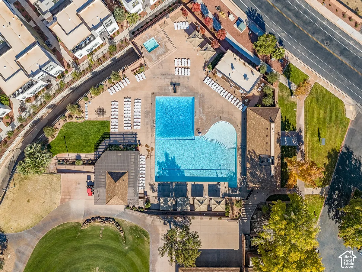 Expansive pool area featuring a large rectangular pool, a curvilinear pool, and an elevated hot tub