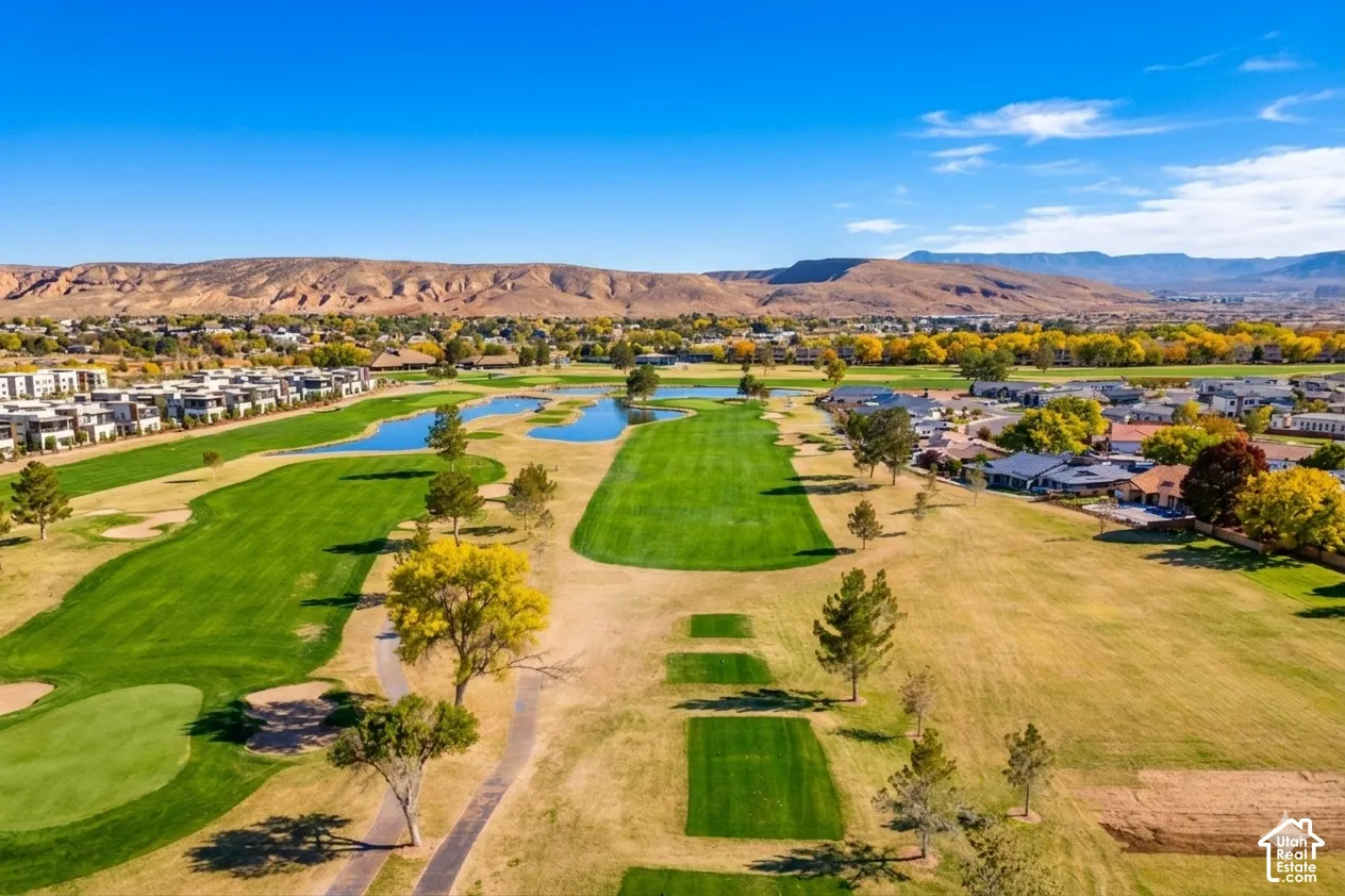 Expansive golf course setting featuring manicured greens, water features, and surrounding residential properties