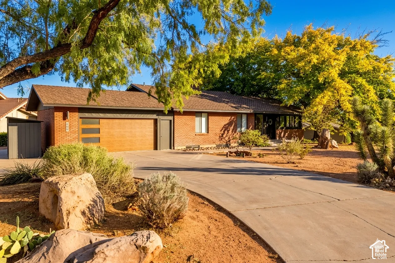 Brick exterior with attached garage featuring horizontal opaque window panels