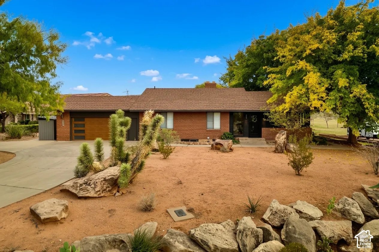 Brick exterior with a brown shingle roof
