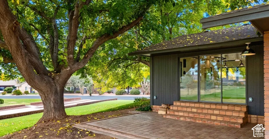 Patio with paver flooring, brick steps, and large glass doors