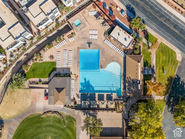 Expansive pool area featuring a large rectangular pool, a curvilinear pool, and an elevated hot tub
