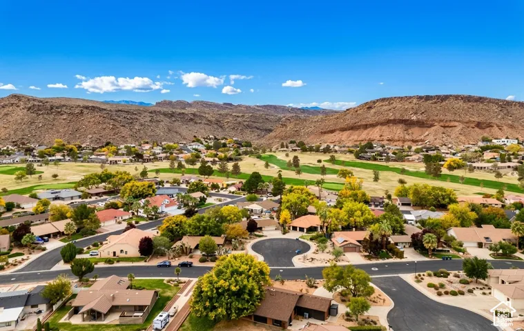 Community featuring residential properties, mature trees, and direct access to a golf course