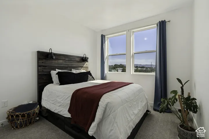 Recessed lighting, light gray carpeting, and multiple windows