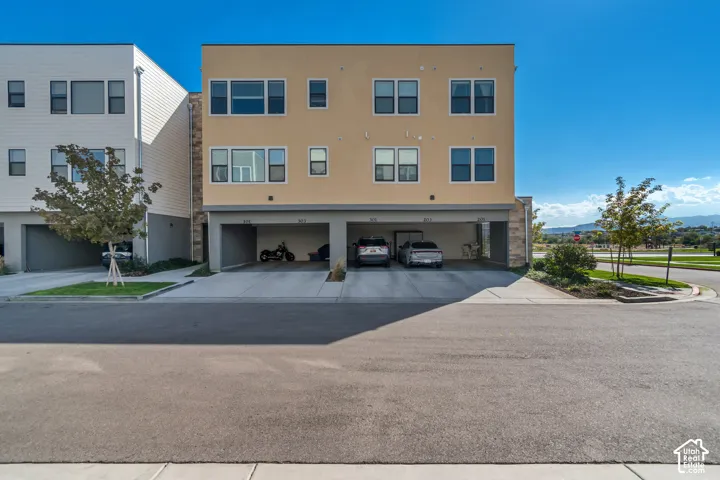 Multi-story building with a stucco exterior and stone accents