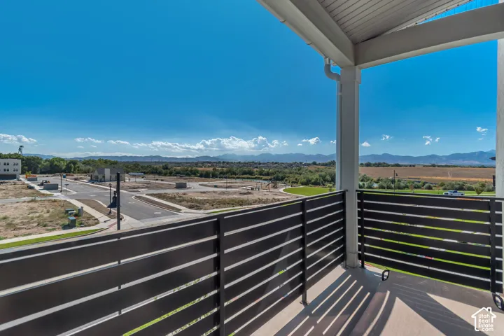Covered outdoor balcony with a slatted privacy railing and durable tile flooring