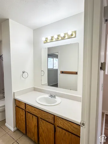 Wood-finish vanity with an integrated sink and light-colored countertop