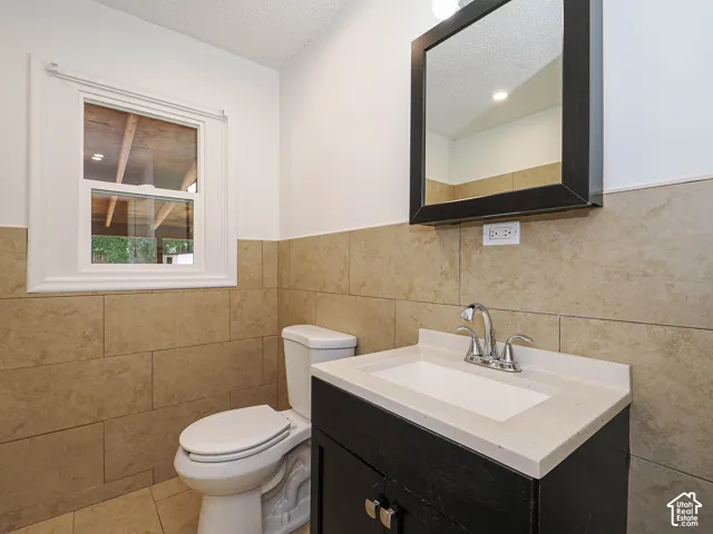 Vanity with integrated sink, chrome-finish faucet, and coordinating framed mirror