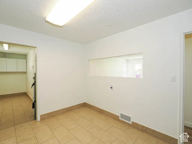 Tile flooring throughout with matching tile baseboards