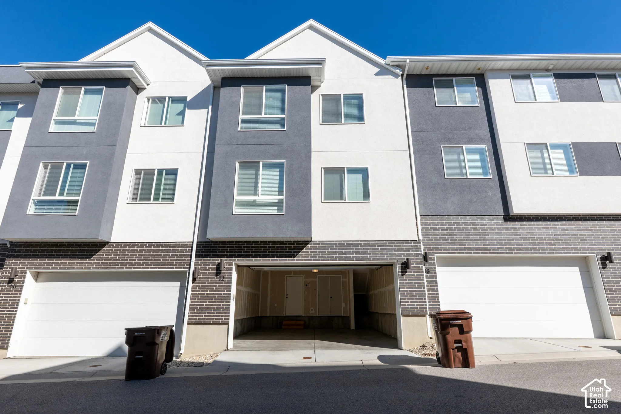Contemporary exterior featuring a multi-tone facade, integrated garage parking, and multiple large windows