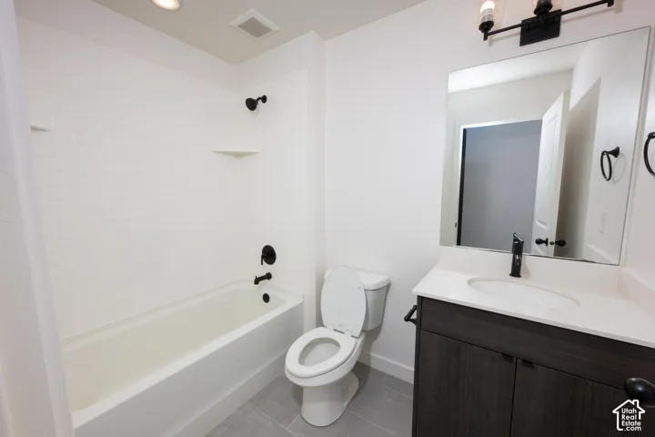 White subway tile tub surround, dark wood-finish vanity with white countertop, integrated sink, matte black faucet, and rectangular mirror