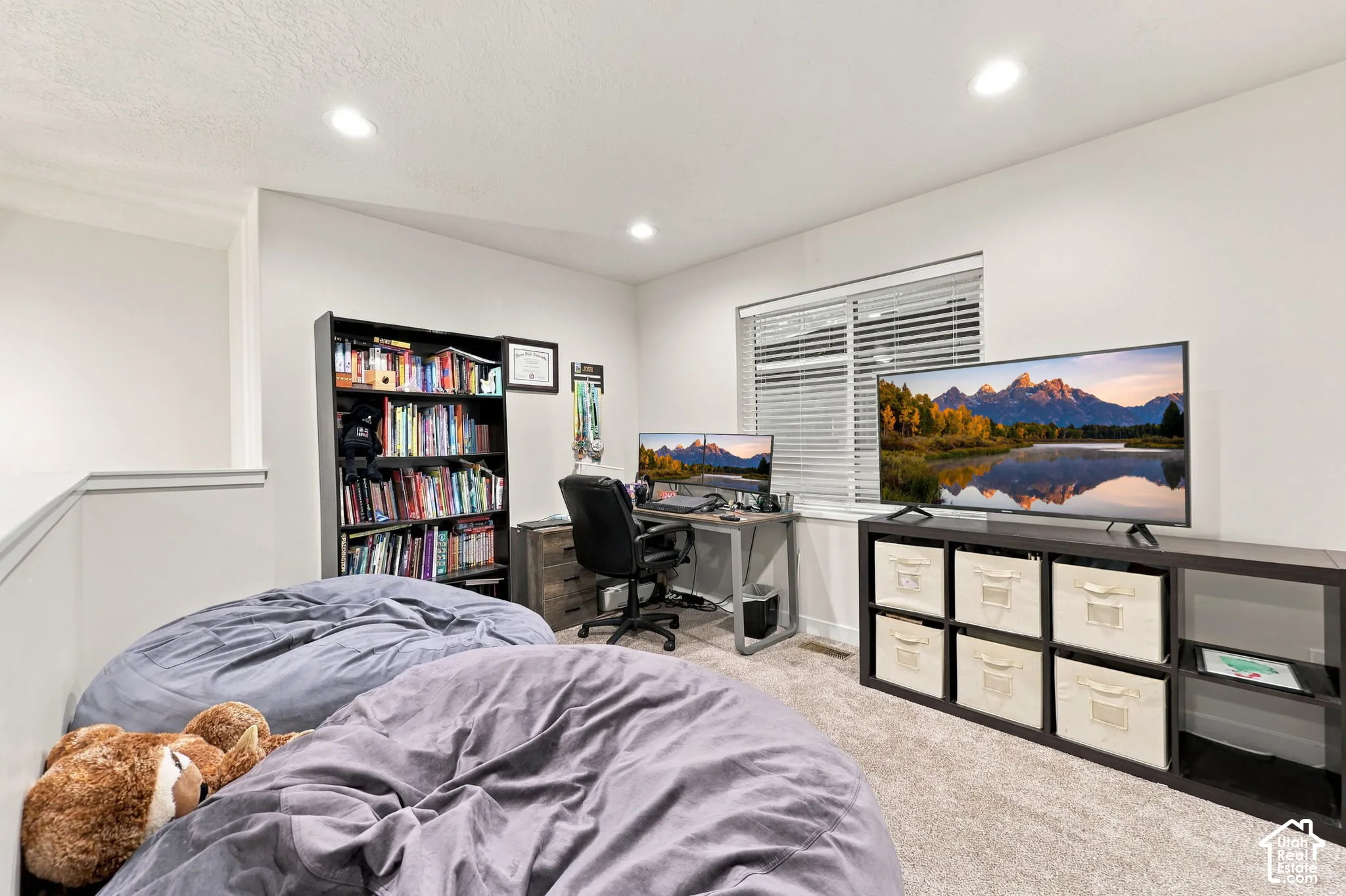 Recessed lighting illuminates the carpeted floor