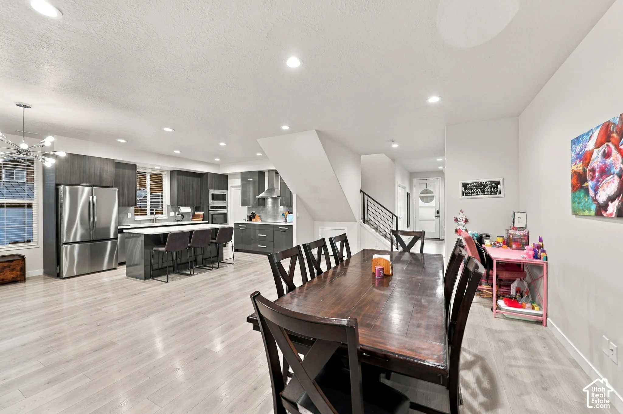 Spacious open-concept living area featuring light wood-finish flooring