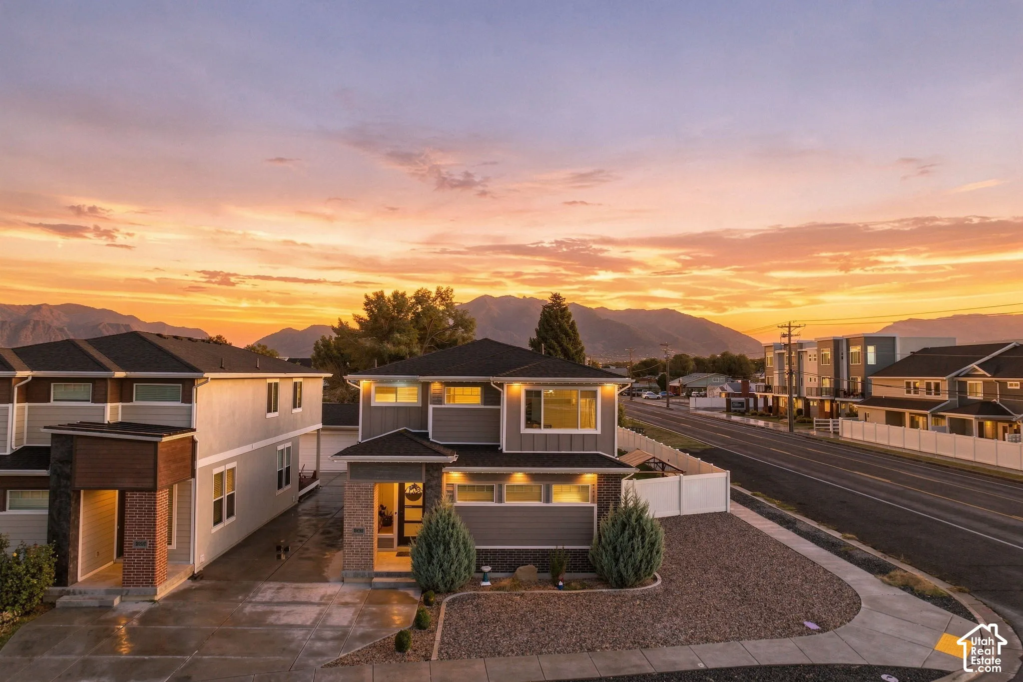 Contemporary exterior with multi-level design, prominent windows, and an attached two-car driveway