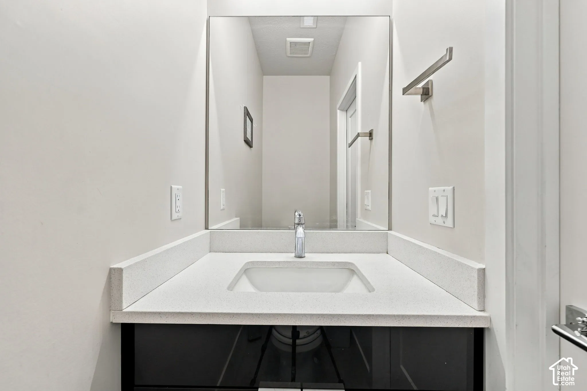 Integrated vanity with a white countertop and rectangular sink