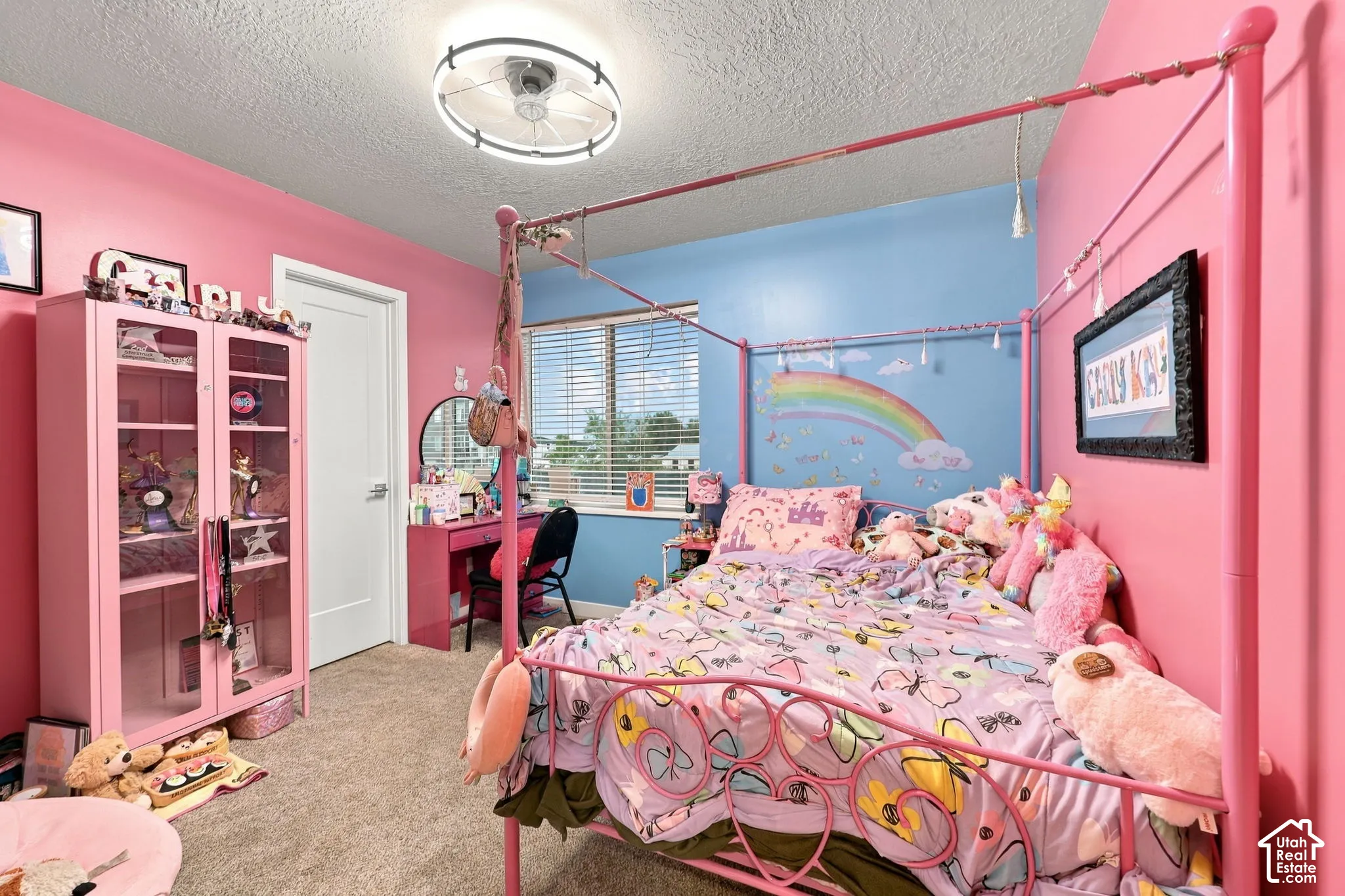 Ceiling-mounted light fixture, window with blinds, and neutral-toned carpeting