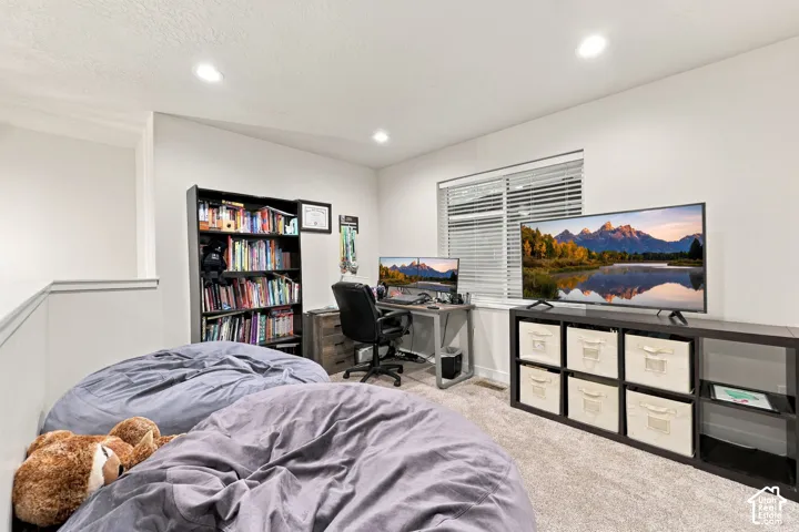 Recessed lighting illuminates the carpeted floor