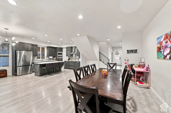 Spacious open-concept living area featuring light wood-finish flooring