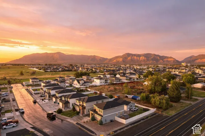 Established residential neighborhood featuring a paved street, sidewalks, and a variety of homes