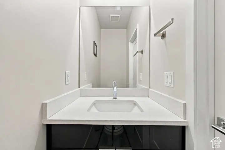Integrated vanity with a white countertop and rectangular sink