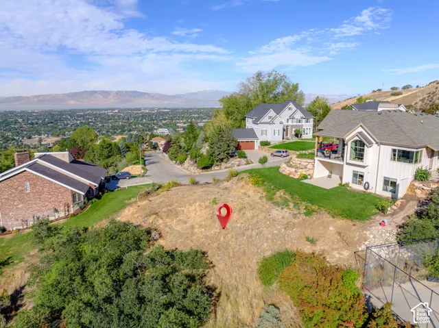 Elevated building site with a mountain backdrop and surrounding residential properties