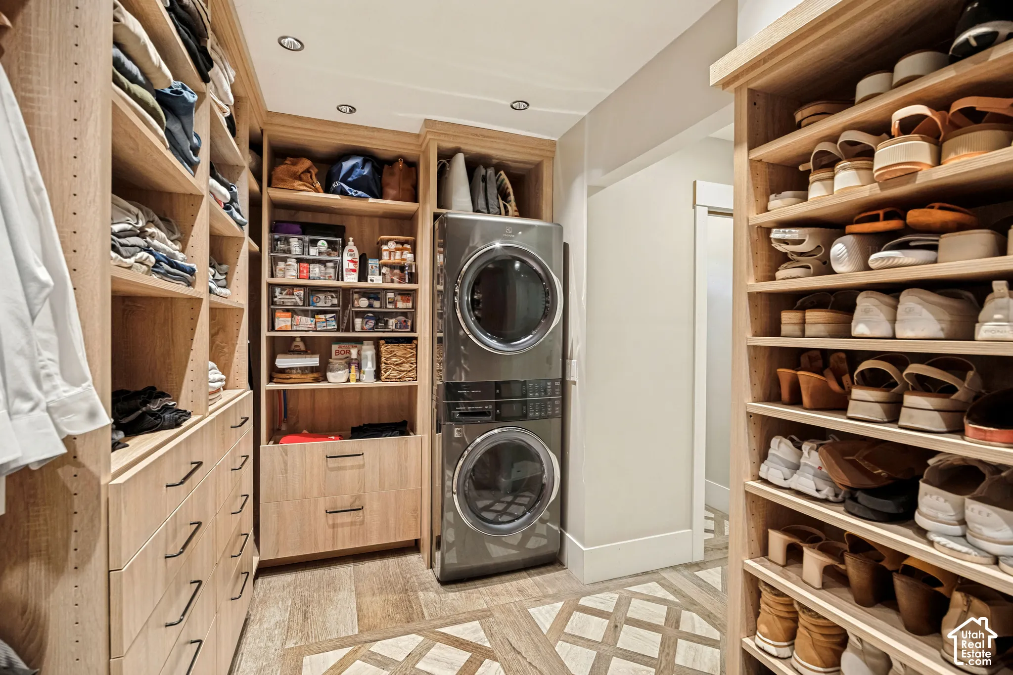 Custom built-in shelving and drawer storage with dark hardware