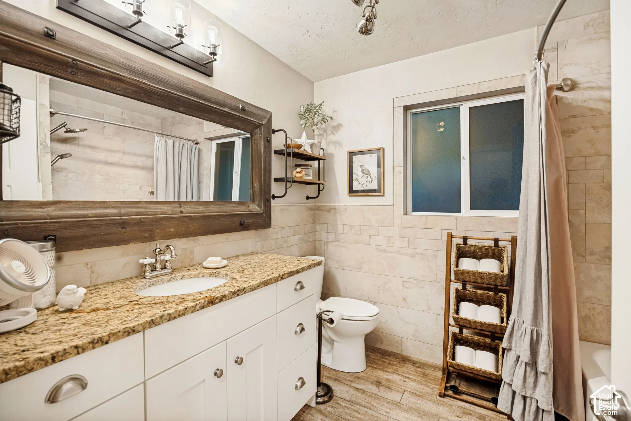 White vanity with a granite countertop and undermount sink