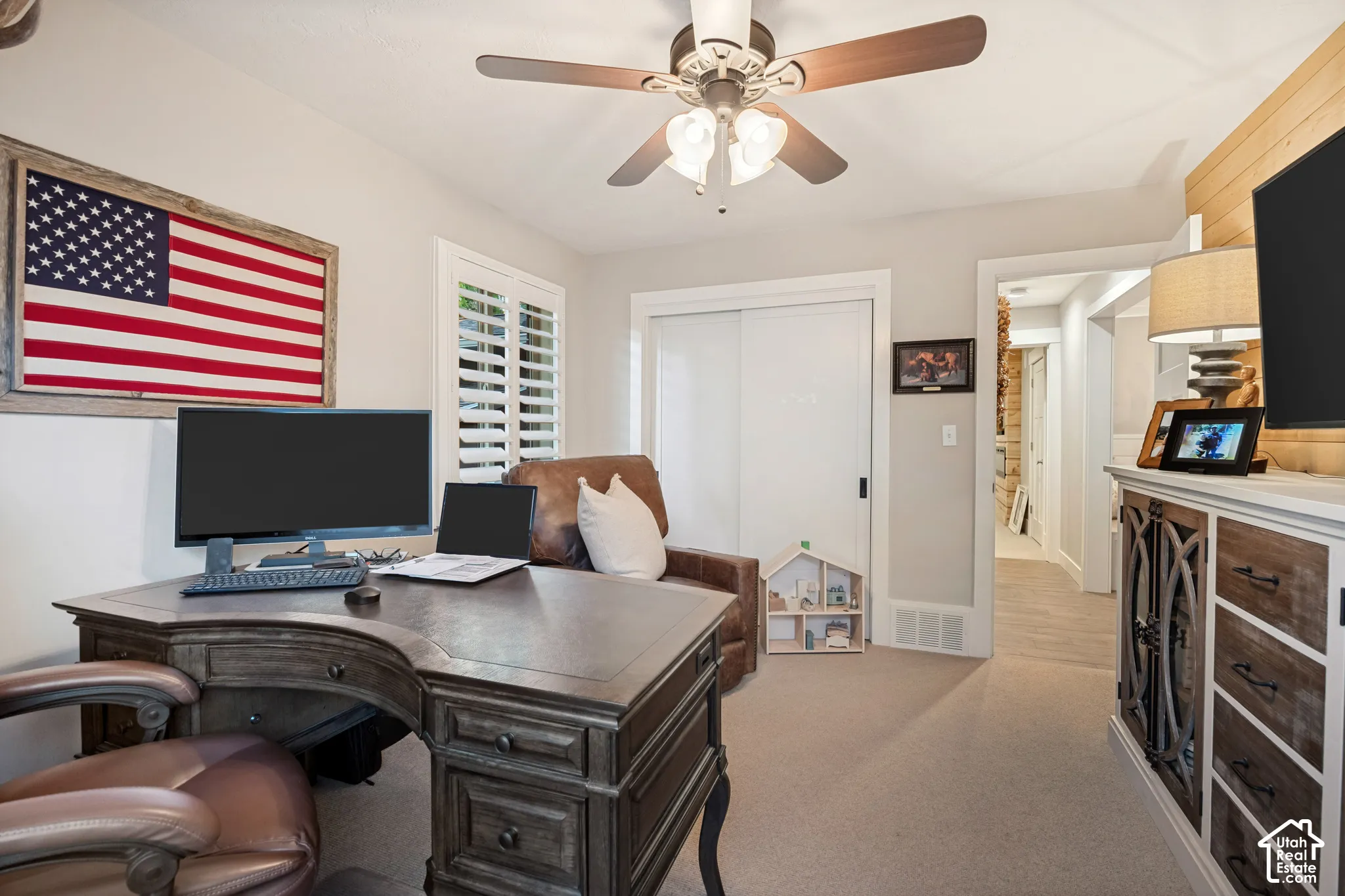 Recessed lighting, ceiling fan, white plantation shutters, built-in closet with sliding doors, and light-toned carpeting