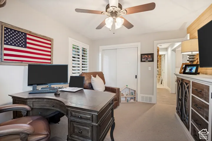 Recessed lighting, ceiling fan, white plantation shutters, built-in closet with sliding doors, and light-toned carpeting