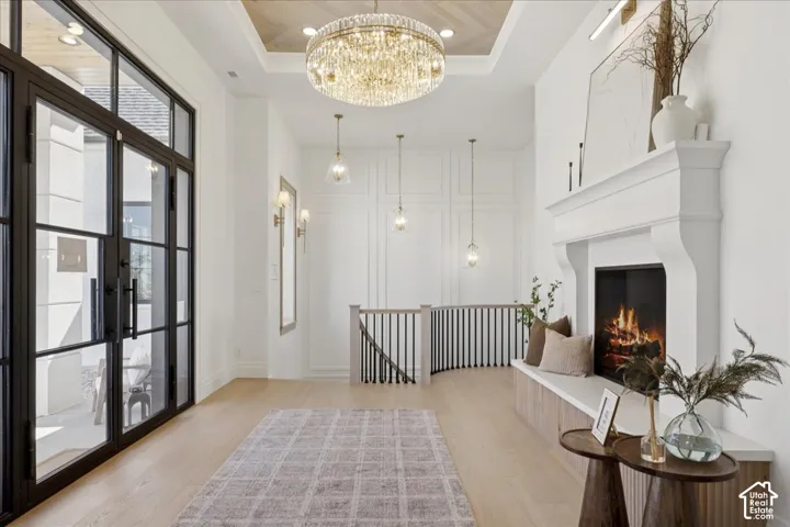 Double-height entry with light wood-finish flooring