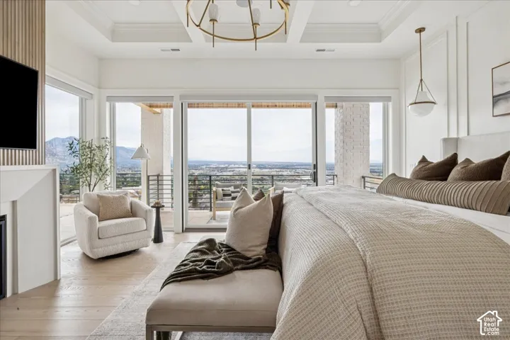 Spacious room with wood-finish flooring, a contemporary ceiling light fixture, and a built-in fireplace