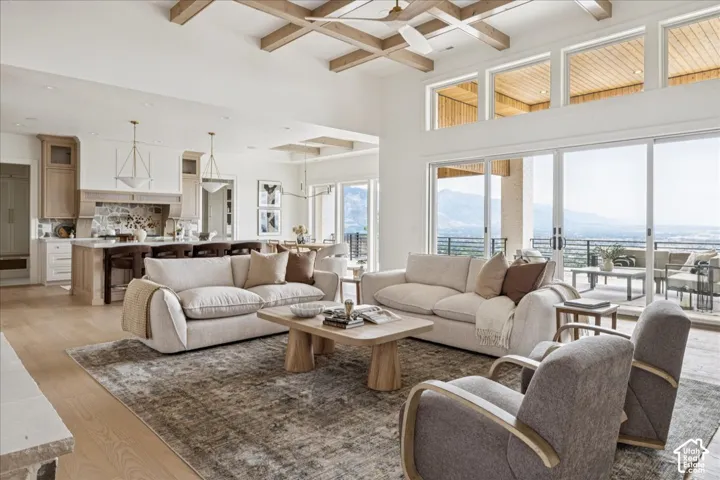 Expansive open-concept living space with high ceilings and wood-finish flooring