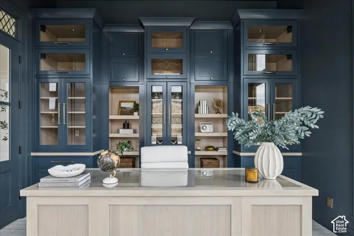 Custom built-in cabinetry with glass-front uppers, integrated lighting, and open shelving