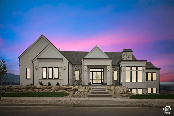 White brick and stone exterior with a dark roof