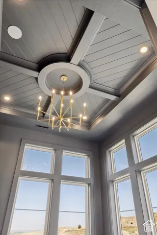 Tray ceiling with shiplap detail, recessed lighting, and a gold-finish chandelier