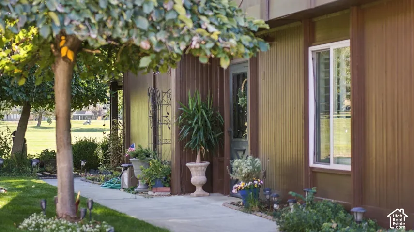 Brown vertical siding exterior with a light-colored window frame and a glass-paneled door