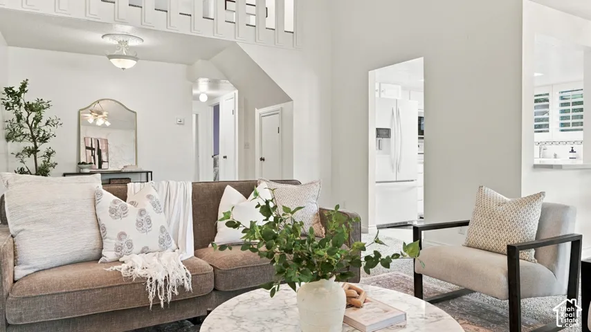 Open concept living area with high ceilings, recessed lighting, and white walls