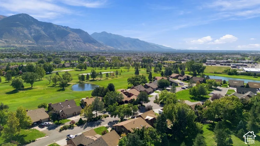 Panoramic mountain backdrop with extensive green spaces and residential properties