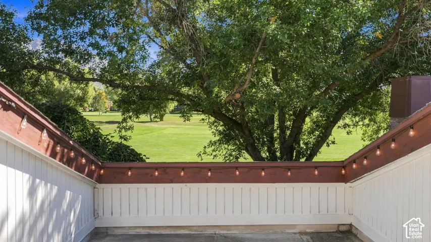 Private patio featuring white vertical siding and brown trim
