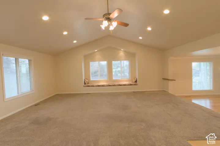 Vaulted ceiling with recessed lighting and ceiling fan