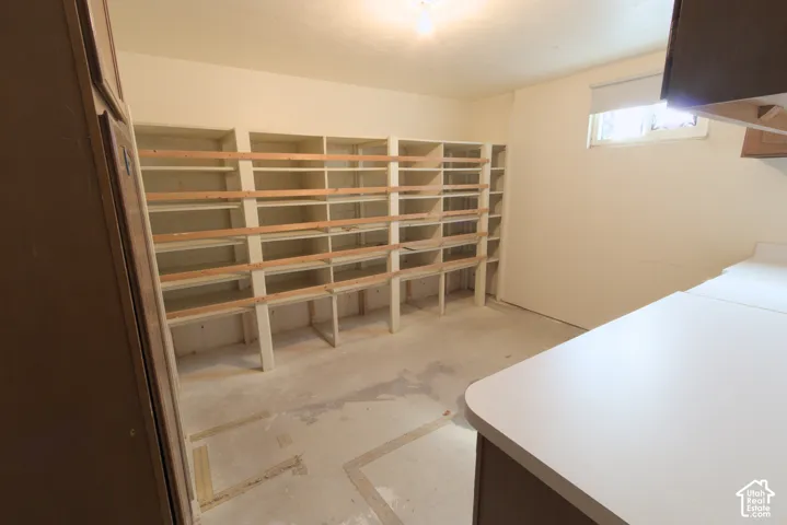 Extensive built-in shelving, durable laminate countertop, and a single-pane window