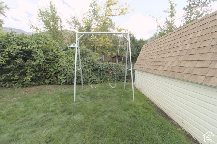 Expansive lawn area with a metal swing set
